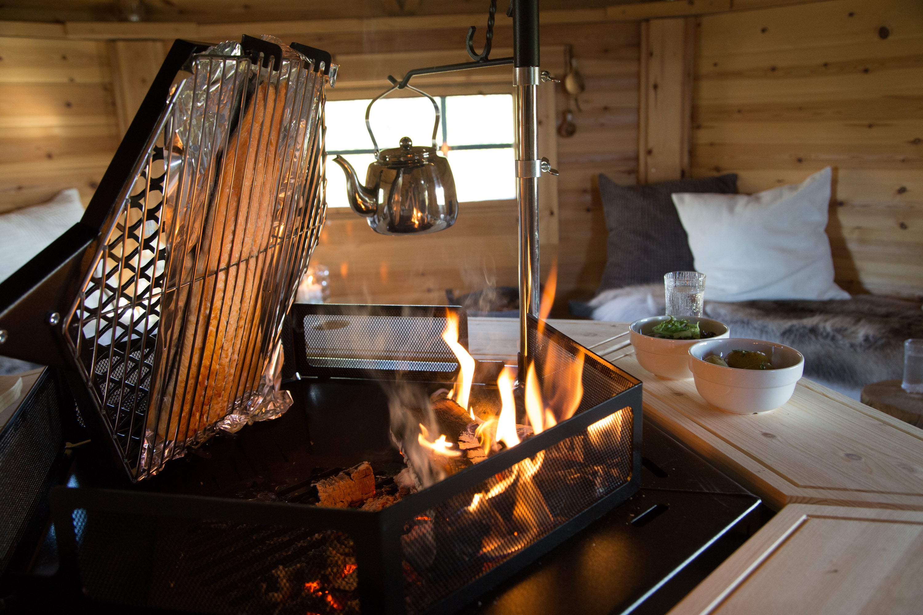 Salmon blazing on the Kota Grill inside a Grill hut.